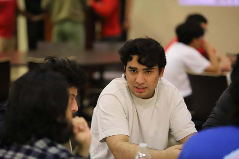 a group of men sitting at a table