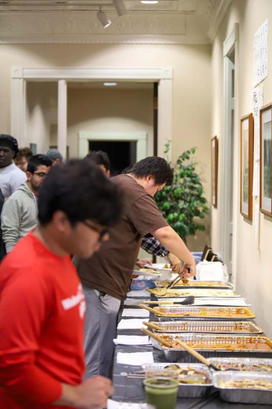 a group of people in a room with food