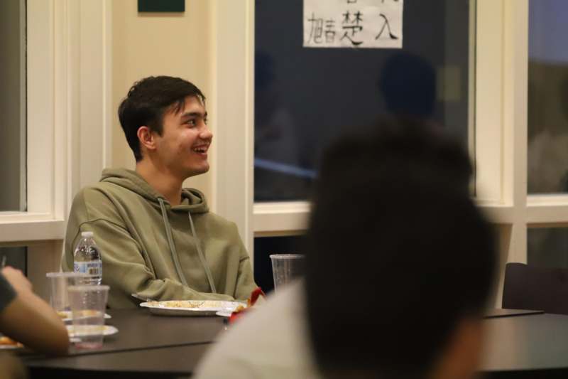 a man sitting at a table with food on it