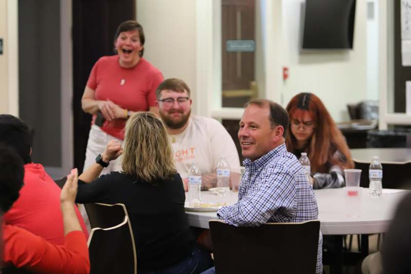 a group of people sitting around a table