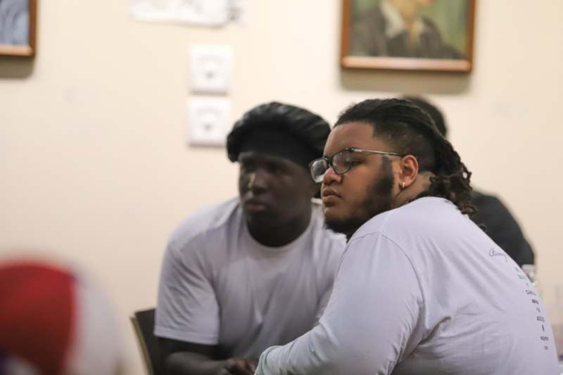a group of men sitting at a table