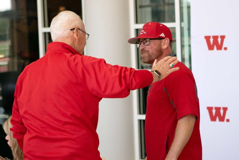 two men in red shirts