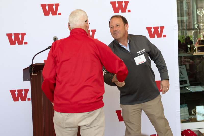 a man shaking hands with another man