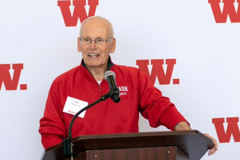 a man standing at a podium with a microphone
