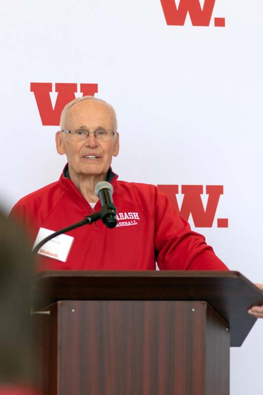a man standing at a podium with a microphone