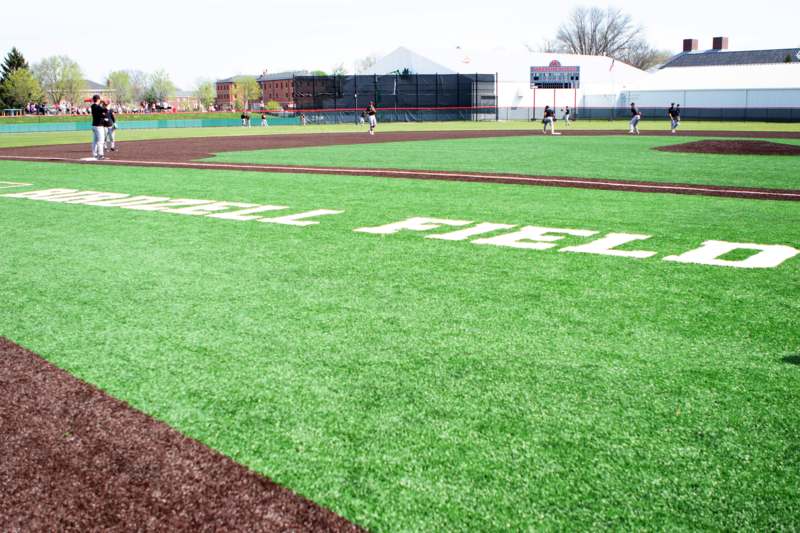 a baseball field with people playing baseball
