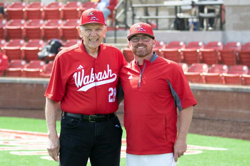 two men standing together in a baseball field
