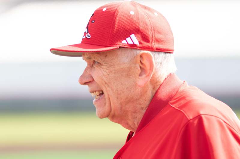 an old man in a red hat
