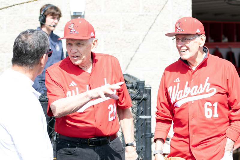 a group of men wearing red baseball uniforms