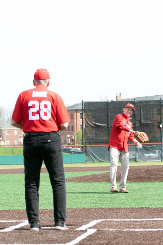 a man in red baseball uniform holding a baseball glove