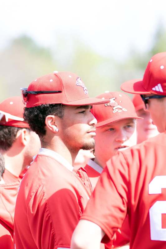 a group of men wearing red baseball uniforms