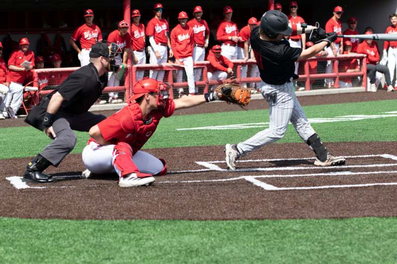 a baseball player sliding into home plate