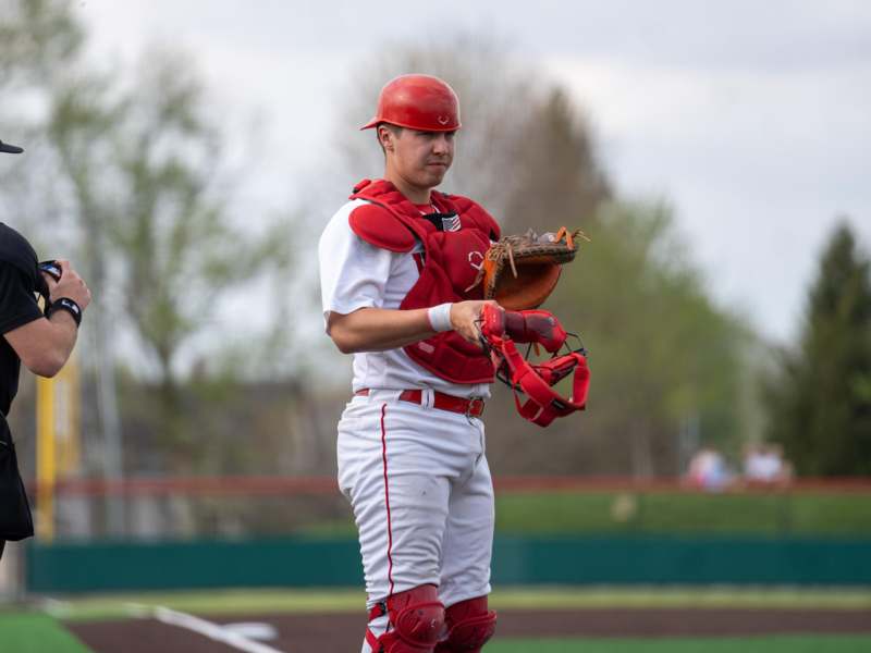 a baseball player holding a glove