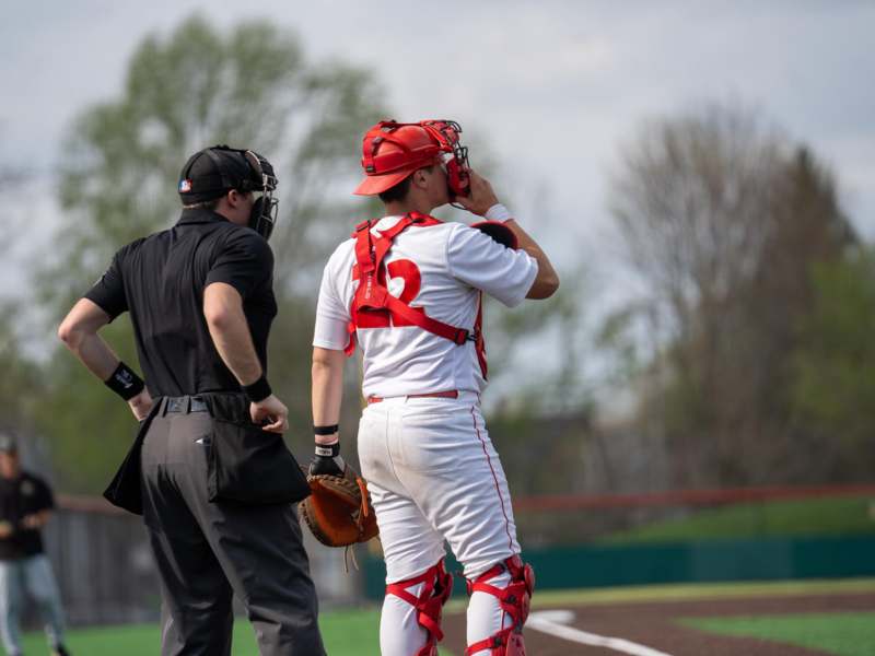a baseball player with a catcher and mitt on a baseball field