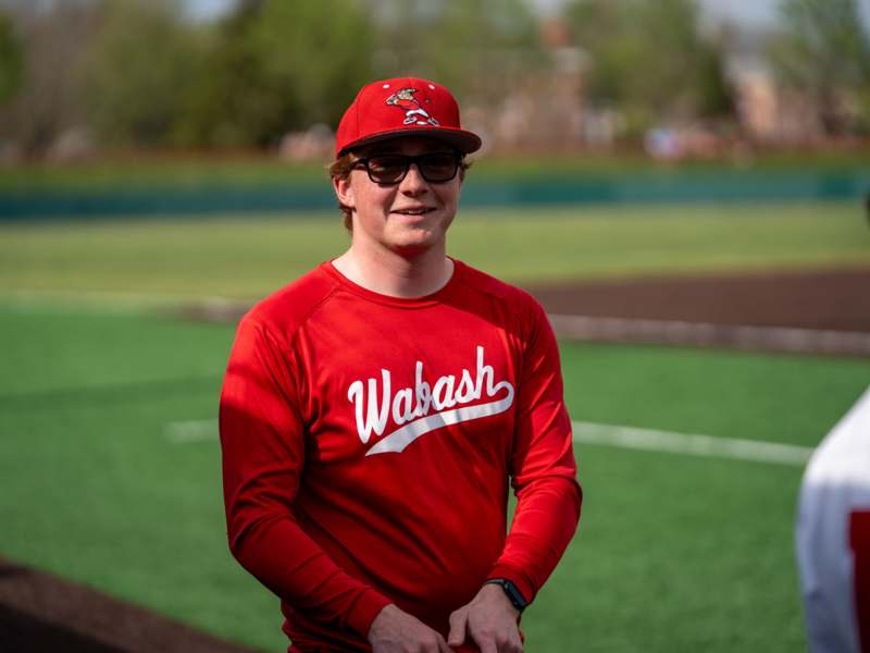 a man in a red baseball cap and red shirt