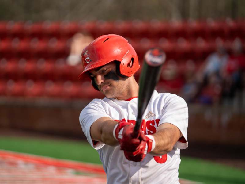 a man holding a baseball bat