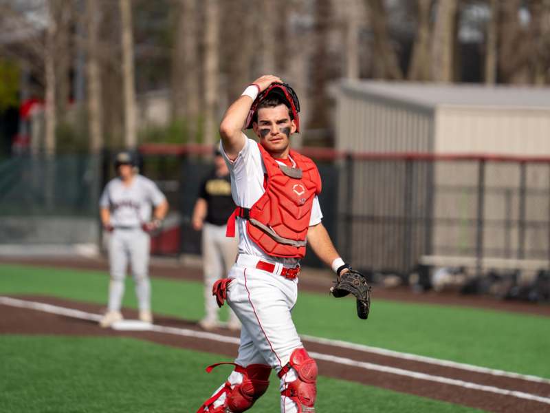 a baseball player holding a glove
