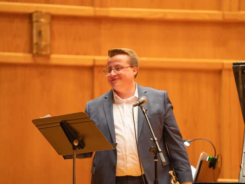 a man standing at a podium with a microphone