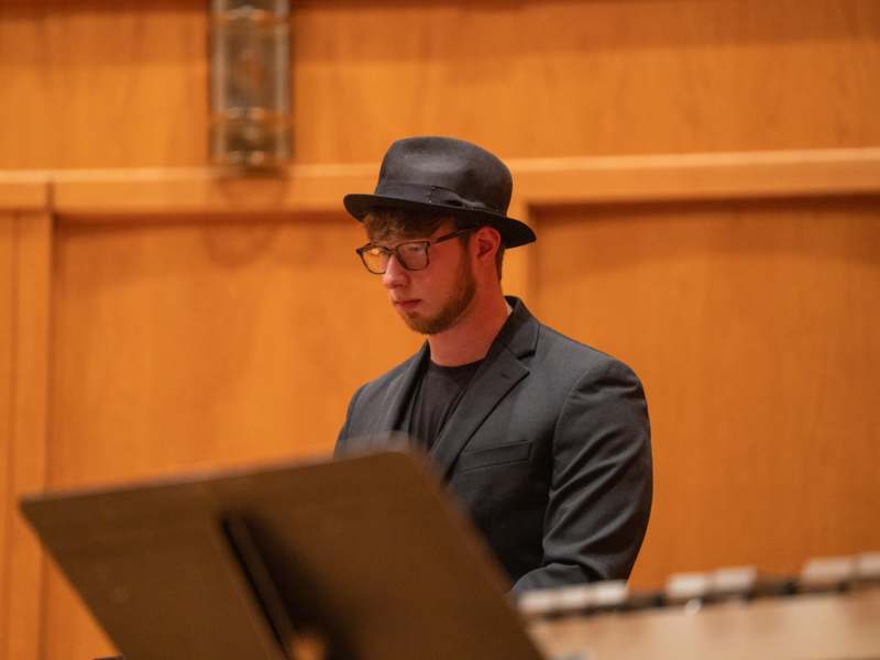 a man in a hat and glasses