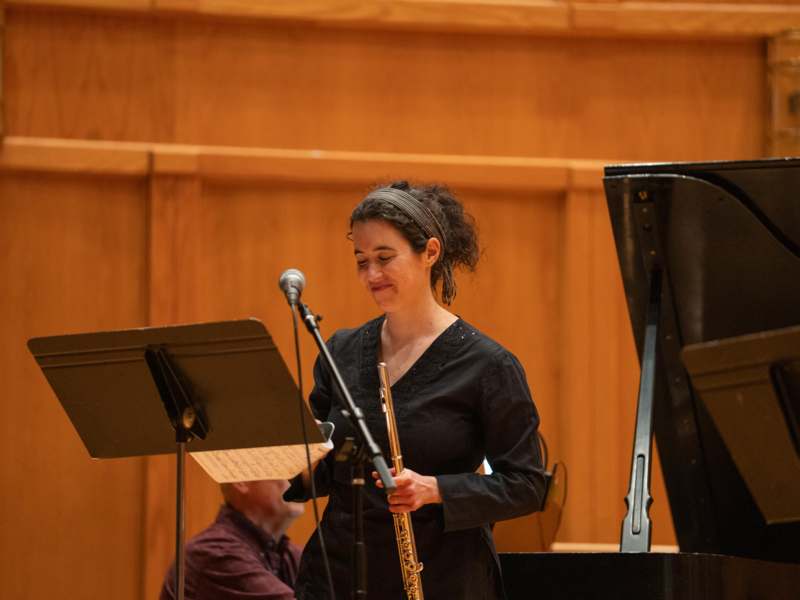 a woman playing a flute