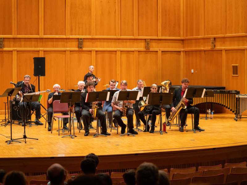 a group of people playing instruments on a stage