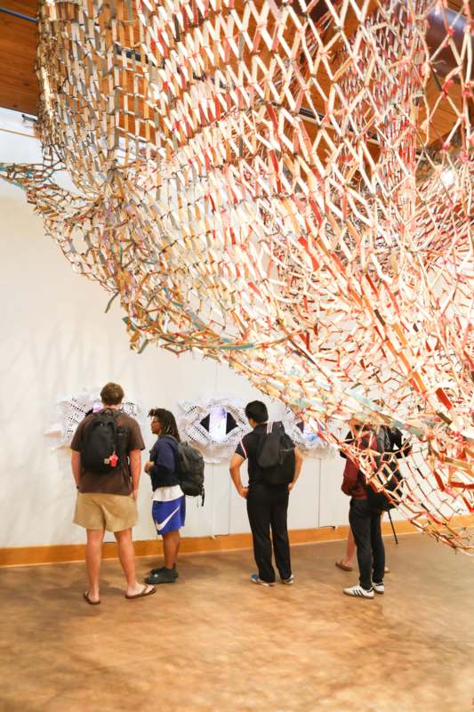 people looking at a sculpture