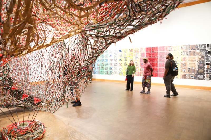 a group of people standing in a room with art