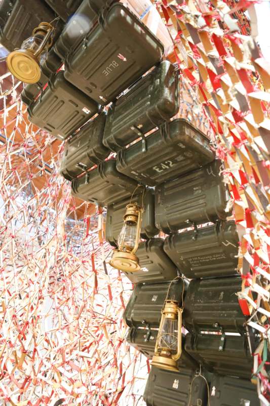 a group of green containers with lanterns from a wall