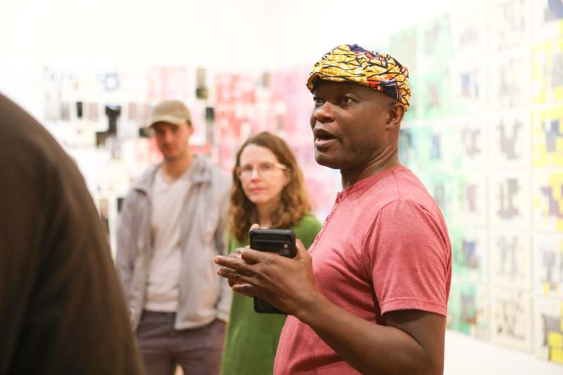 a man holding a phone in front of a group of people