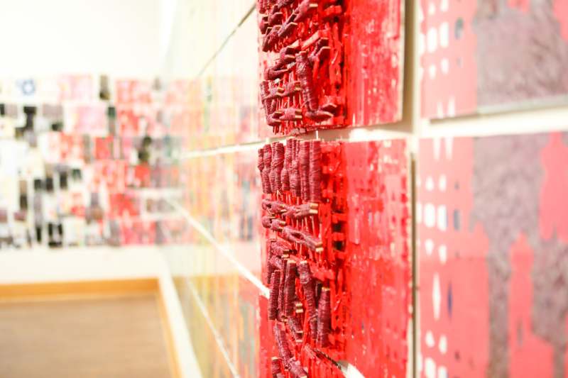 a wall with red pieces of paper