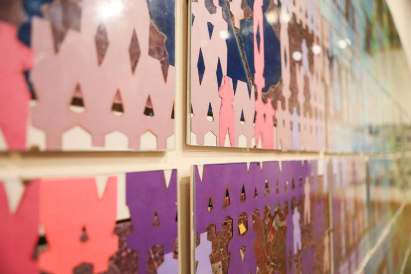 a wall with many pieces of art