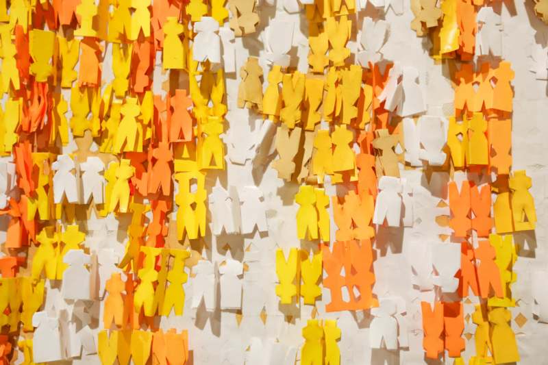 a group of cut out paper people