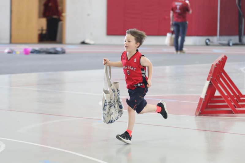 a boy running with a bag
