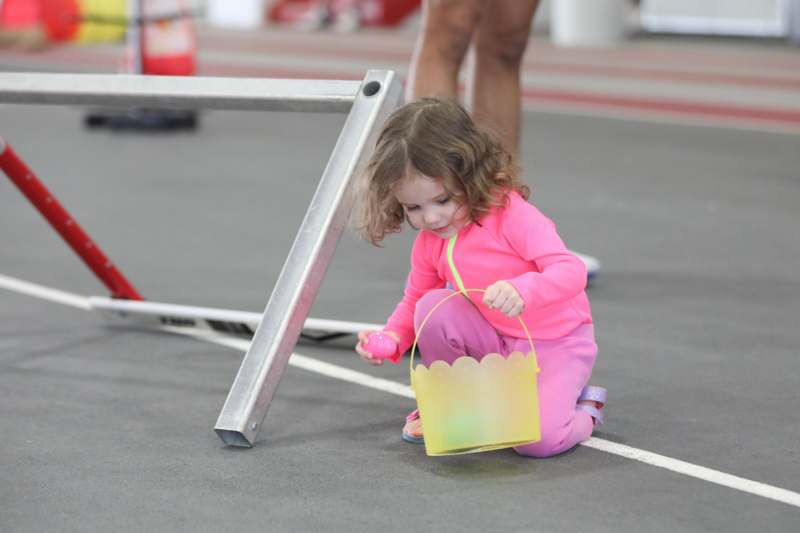 a child holding a yellow bucket