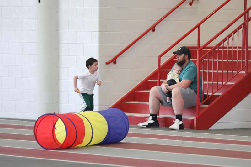 a man holding a baby on a staircase