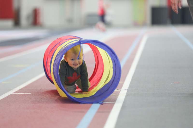 a baby playing in a tunnel