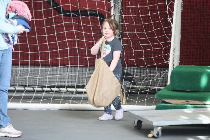 a girl holding a brown bag