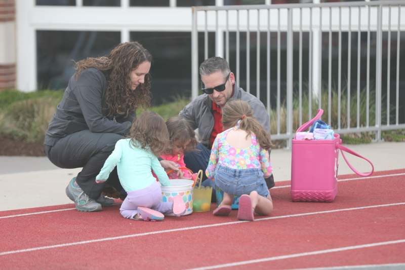 a man and woman with children on a track