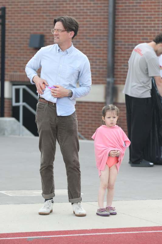 a man and a girl standing outside