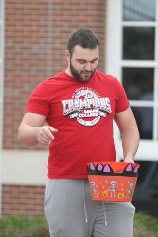 a man pointing at a bucket