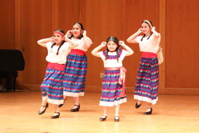 a group of girls wearing colorful skirts