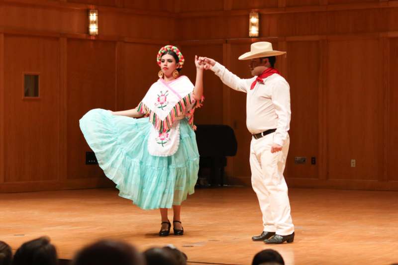 a man and woman dancing on a stage