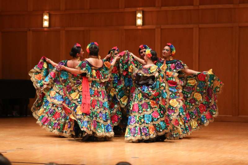 a group of women wearing colorful dresses