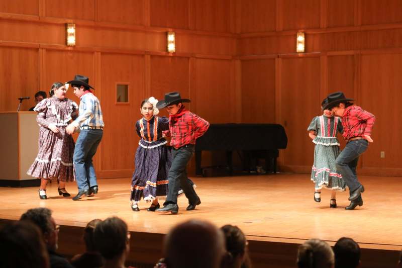 a group of kids dancing on a stage