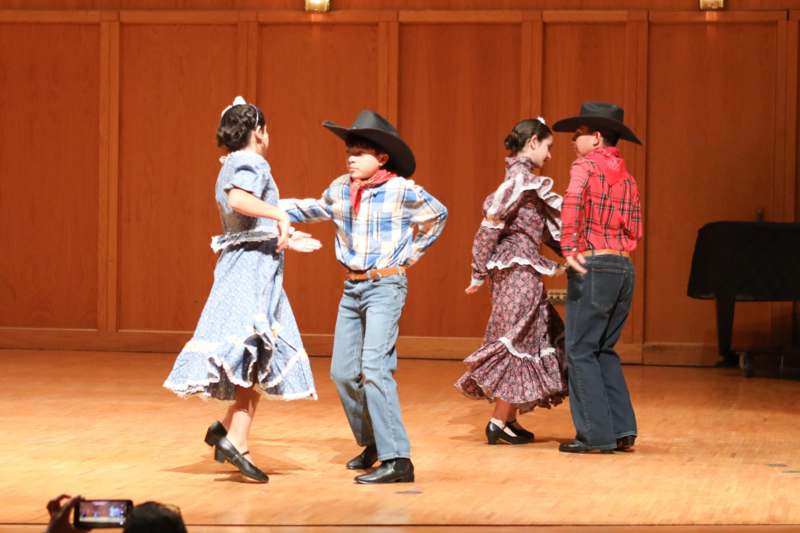 a group of kids dancing on a stage