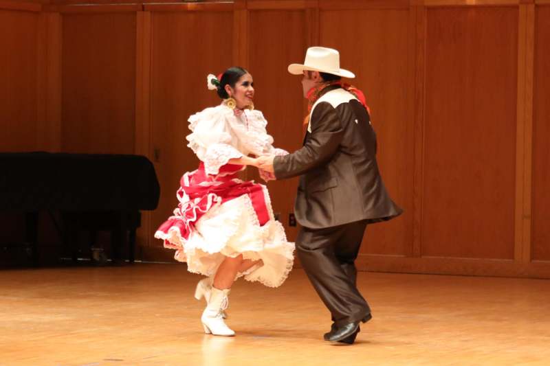 a man and woman dancing on a stage