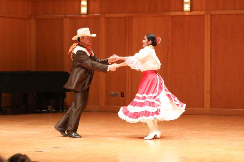 a man and woman dancing on a stage