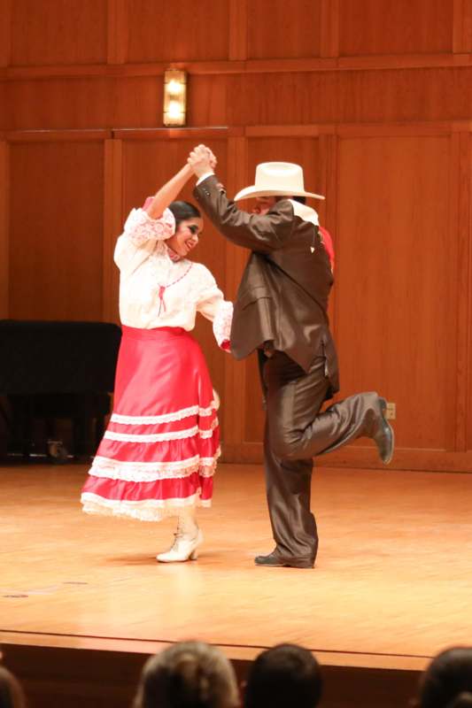 a man and woman dancing on a stage