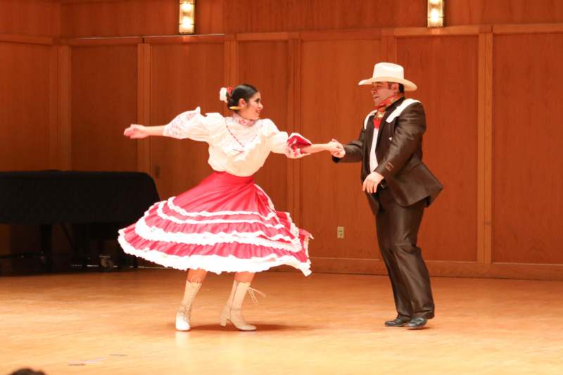 a man and woman dancing on a stage