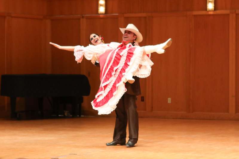a man holding a woman in a dress